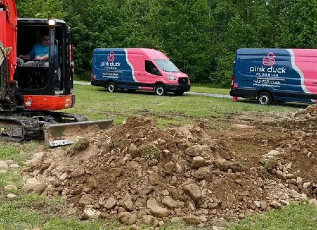 Plumber using water extraction equipment after pipe burst in Mount Carmel commercial building
