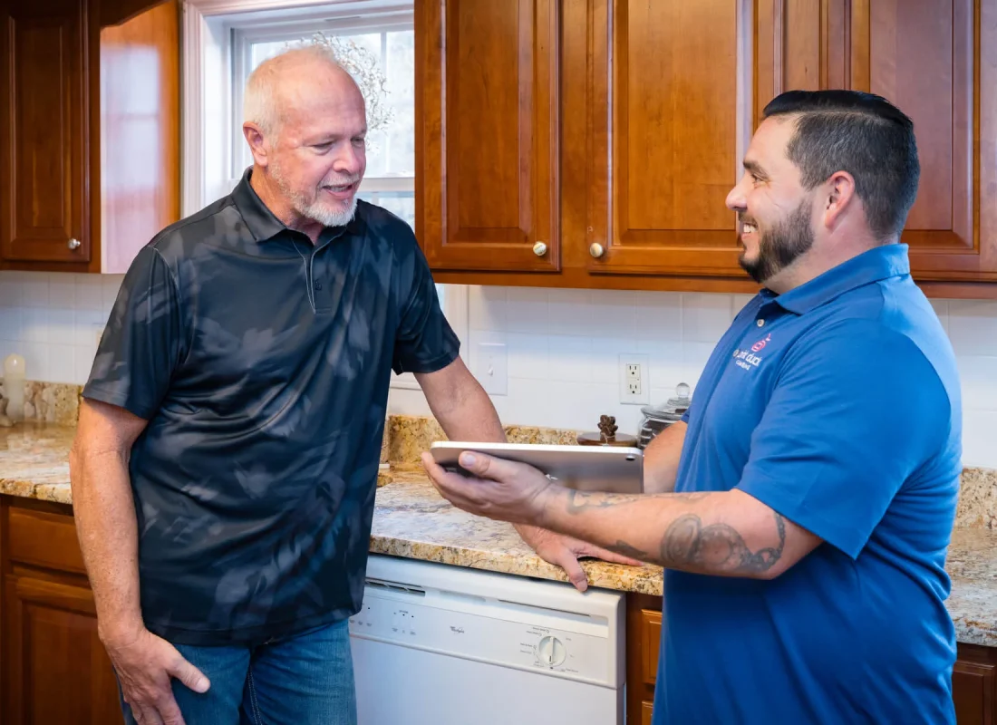 Licensed technician troubleshooting electric water heater in Johnson City, TN utility closet