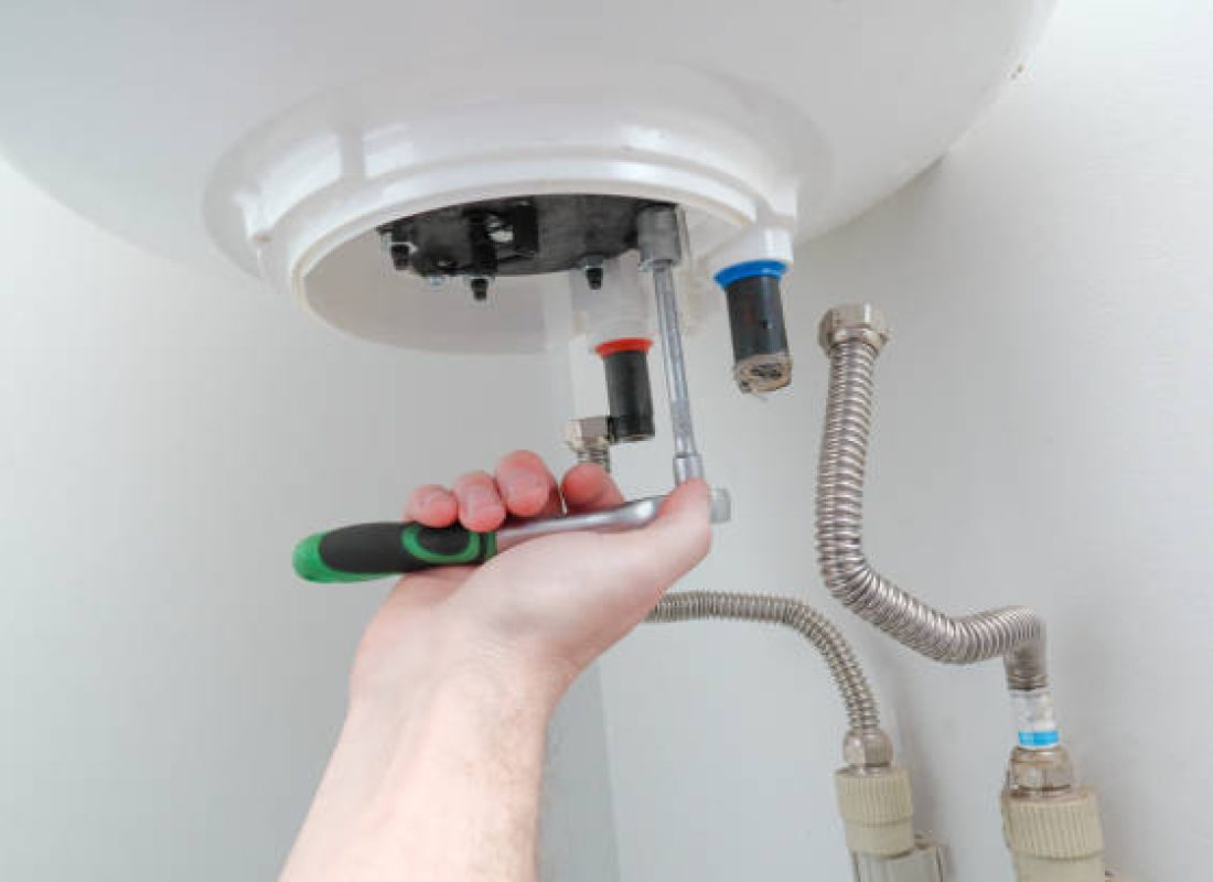 Water Heater Replacement in Gray, TN as a plumber installs a new tank in a utility room